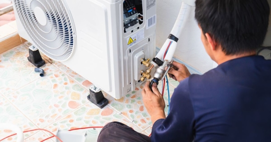 man working on AC unit